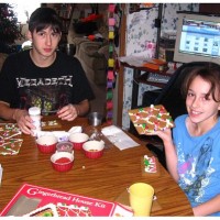 kids making gingerbread house