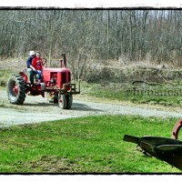old red tractor on road