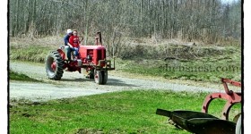 old red tractor on road