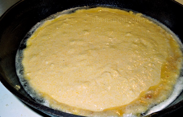 pour cornbread mix into cast iron skillet 