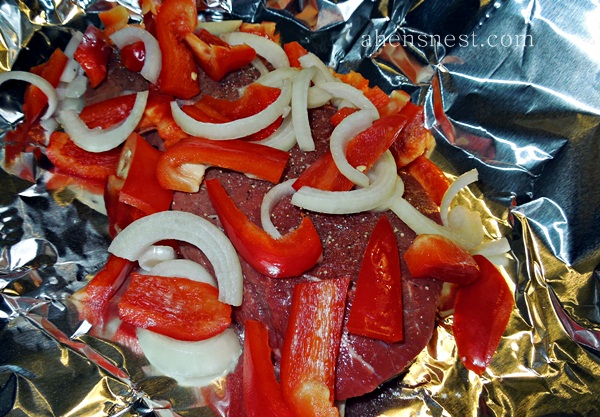 london broil and peppers in aluminum foil